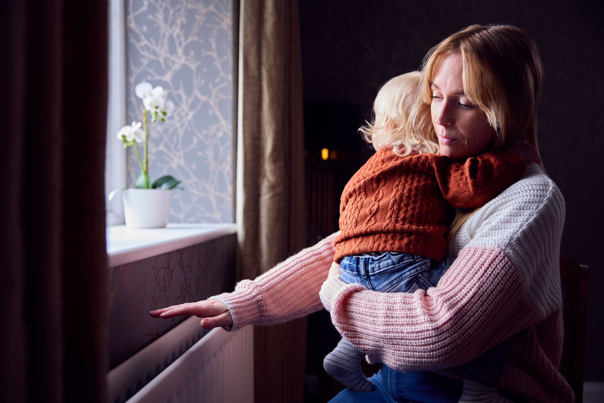 Woman and young child in cold home
